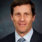 Headshot of John T Raymond