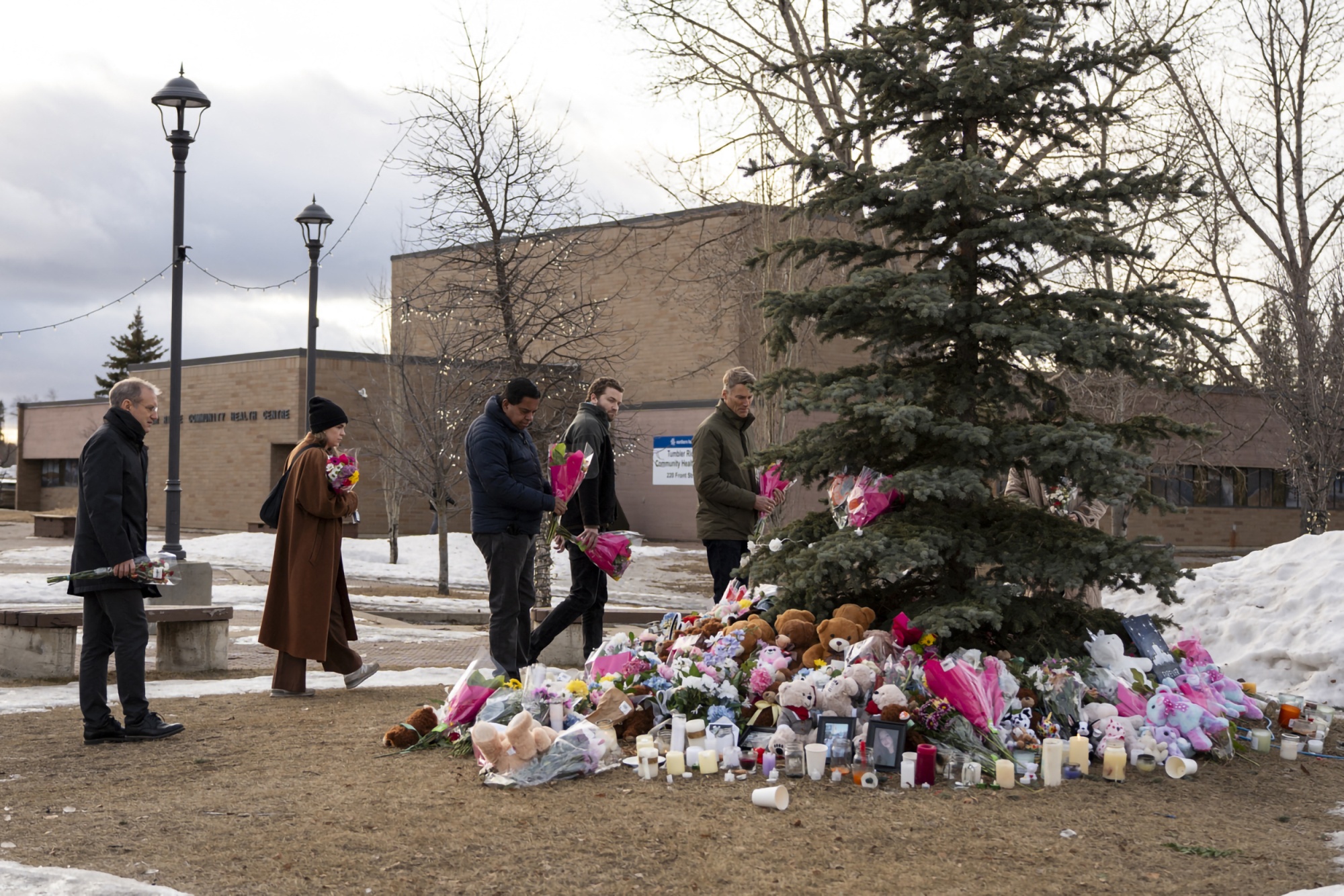 People bring flowers and pay their respects at a community vigil in Tumbler Ridge, British Columbia on Feb. 12. 
