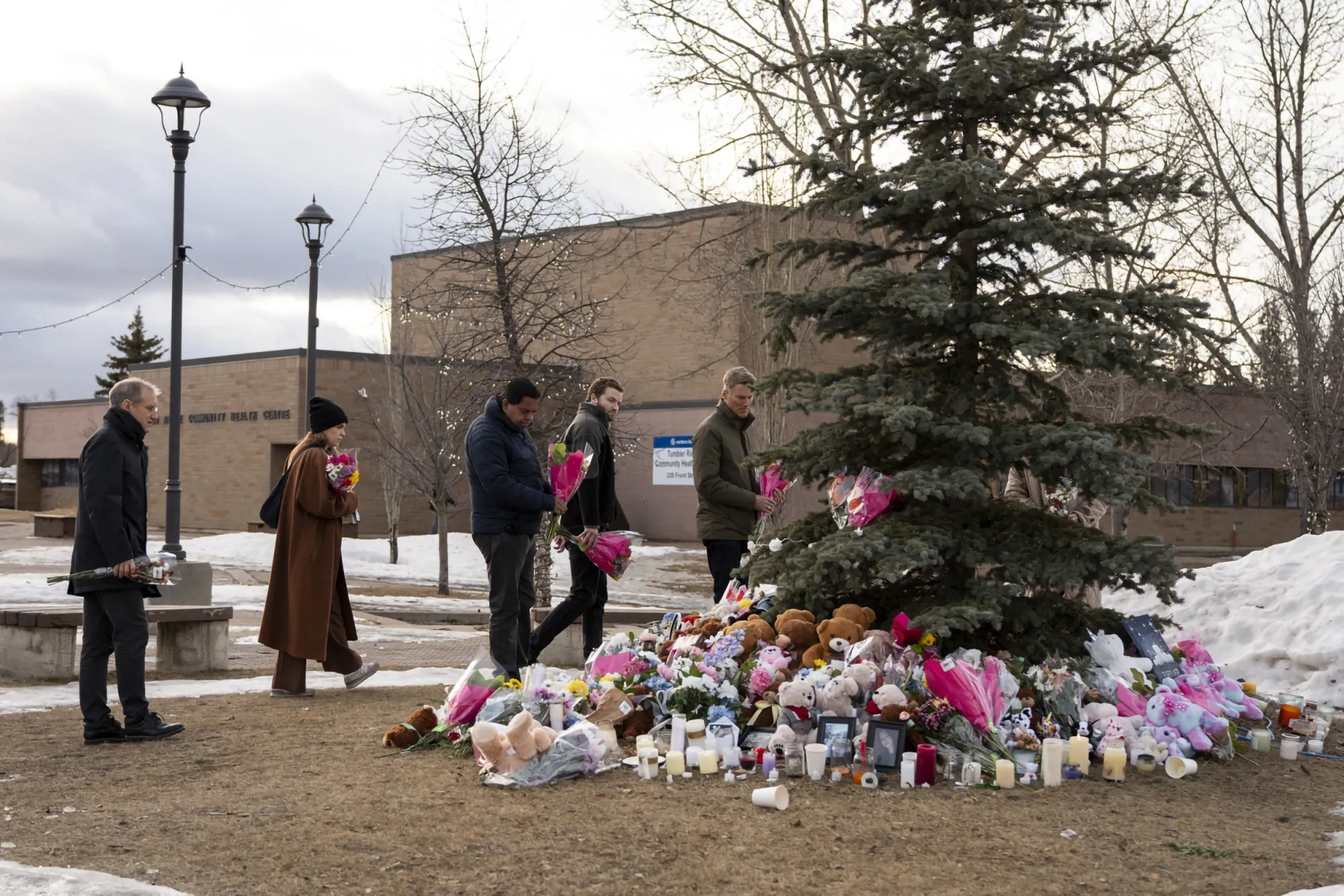 People bring flowers and pay their respects at a community vigil in Tumbler Ridge, British Columbia on Feb. 12.&nbsp;