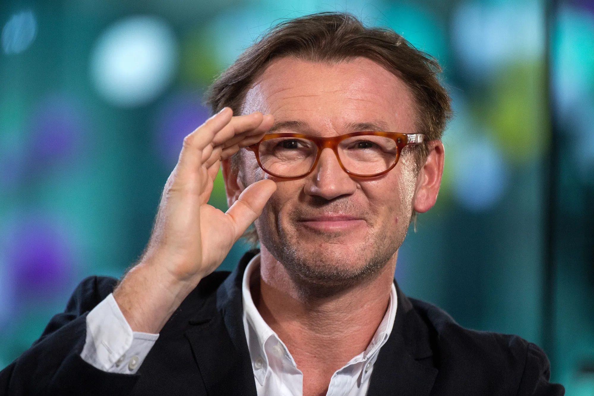 Hugh Hendry, hedge fund manager at Eclectica Asset Management, adjusts his glasses during a Bloomberg Television interview.