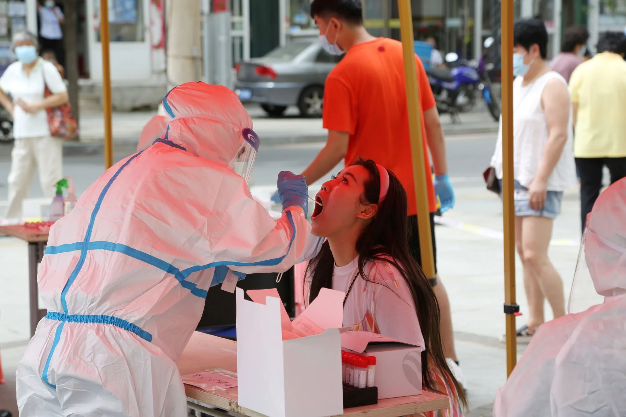 A health worker carries out a Covid-19 test in Dalian, July 27.