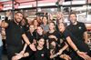 Actress and singer Selena Gomez poses in the middle of a group of Sephora employees at a store in Paris.