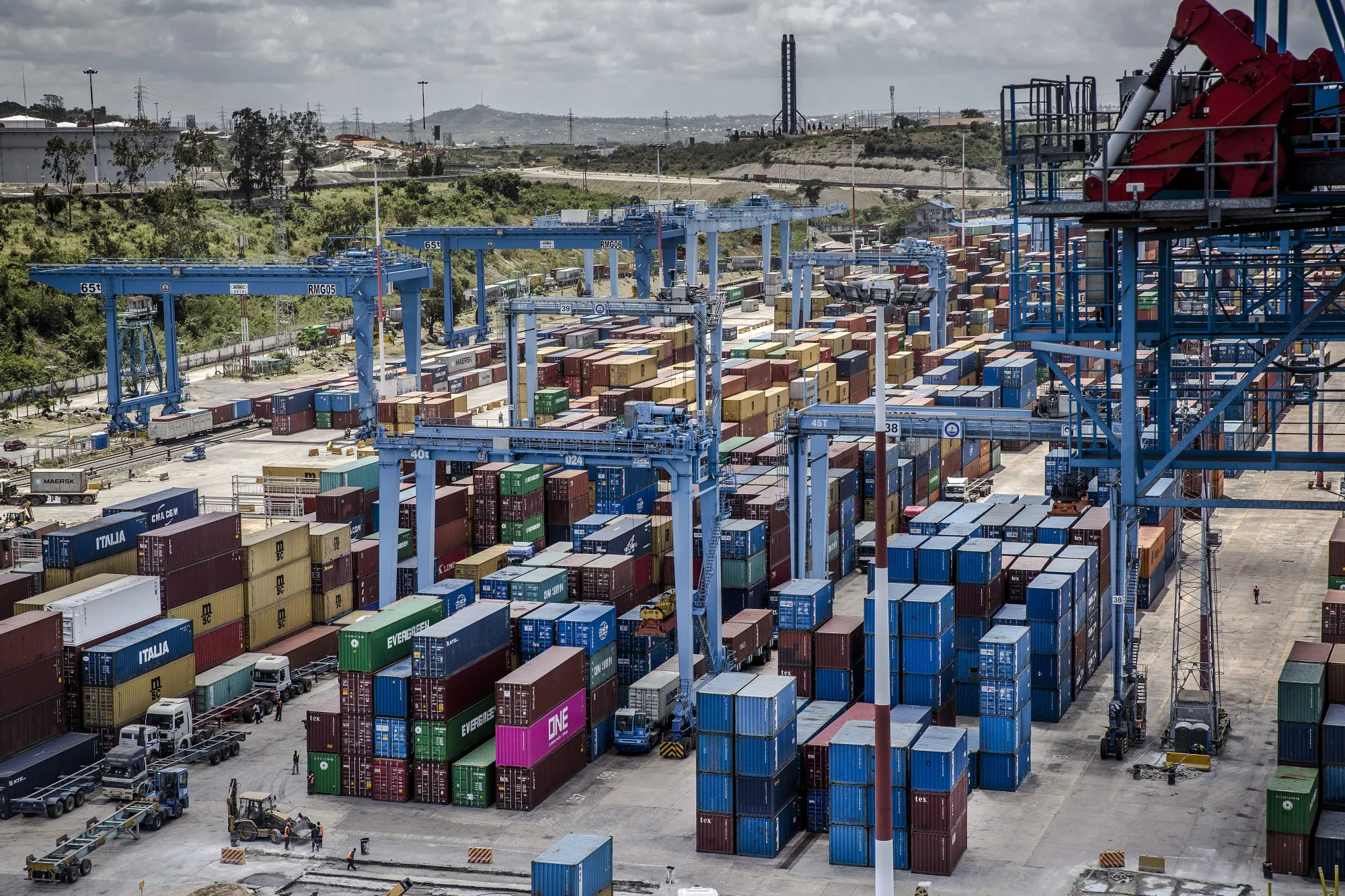 Shipping containers stand beneath gantry cranes on the dock at Mombasa port, operated by Kenya Ports Authority, in Mombasa, Kenya.