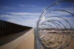 A concertina barbed wire fence stands next to a border fence that separates the U.S. and Mexico stands in Santa Teresa, New Mexico, U.S.
