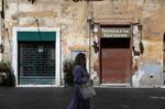 A pedestrian passes a closed restaurant in Rome, Italy, on&nbsp;May 19.