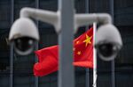 The flag of China is flown behind a pair of surveillance cameras outside the Central Government Offices in Hong Kong, China, on Tuesday, July 7, 2020, days after Beijing imposed&nbsp;national security legislation on the city.