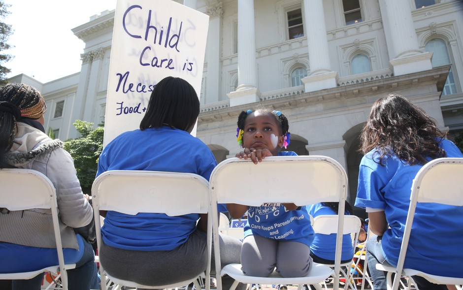 Saryah Mitchell, 4, sits with her mother, Teisa, left, at a rally calling for increased child care subsidies in Sacramento on May 6, 2015.