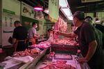 Customers purchase pork at a food market in Shanghai, earlier in June.