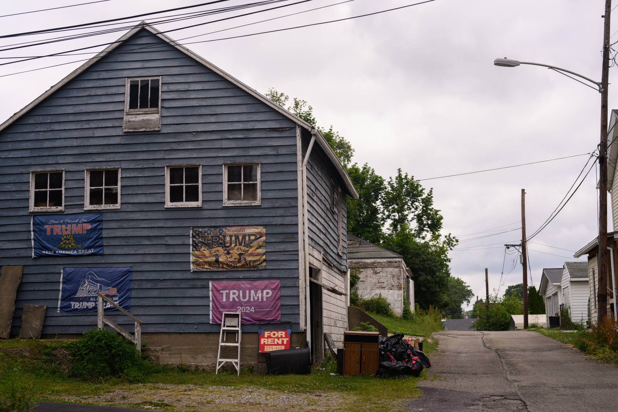 Trump flags are displayed on a garage of a Westmoreland County home on June 3, 2024 in Southwest Greensburg, Pa.