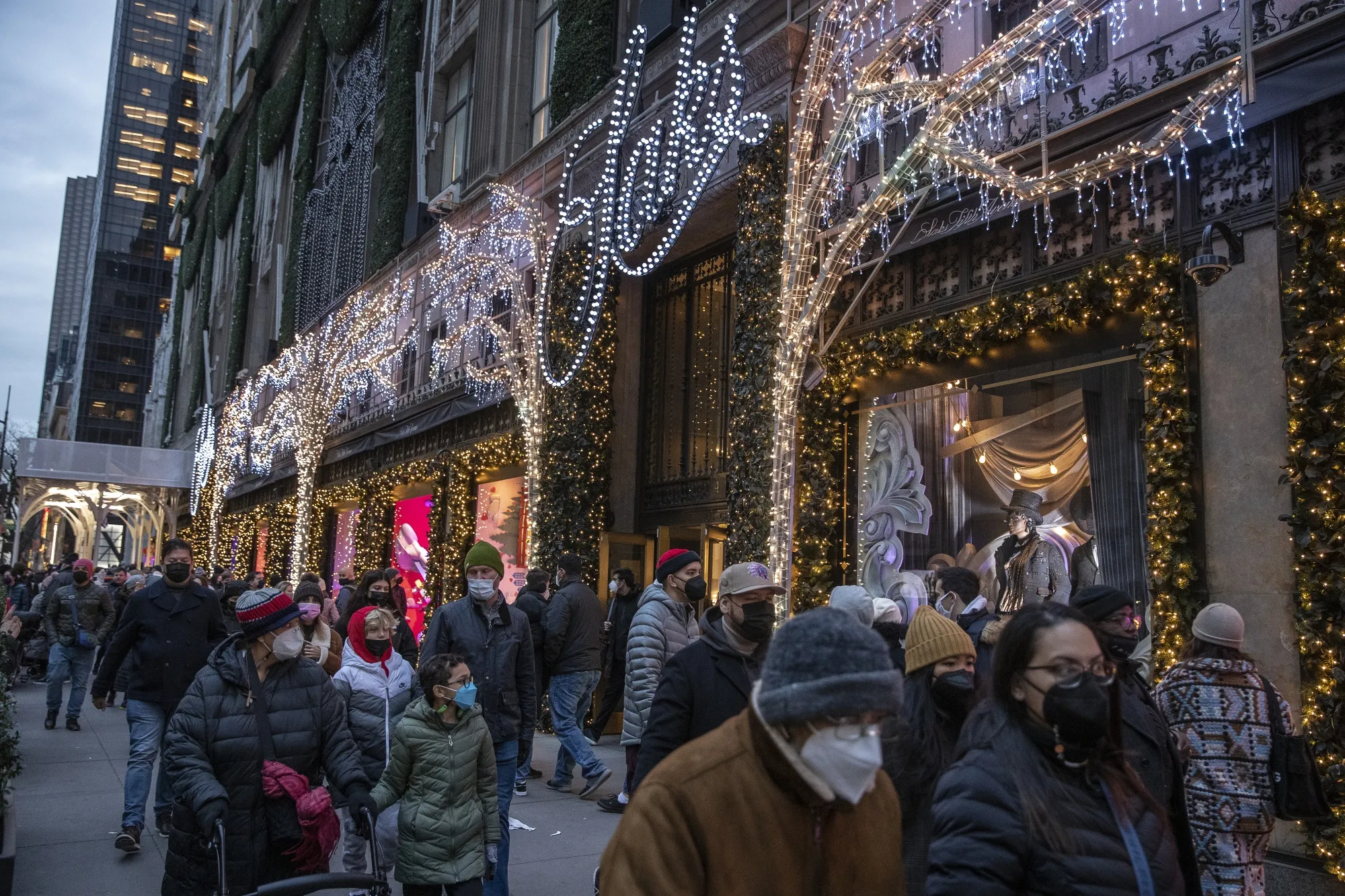 Shoppers walk past Saks Fifth Avenue in New York City.