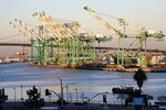 Container cranes stand idle at the Port of Los Angeles in Los Angeles, California. 