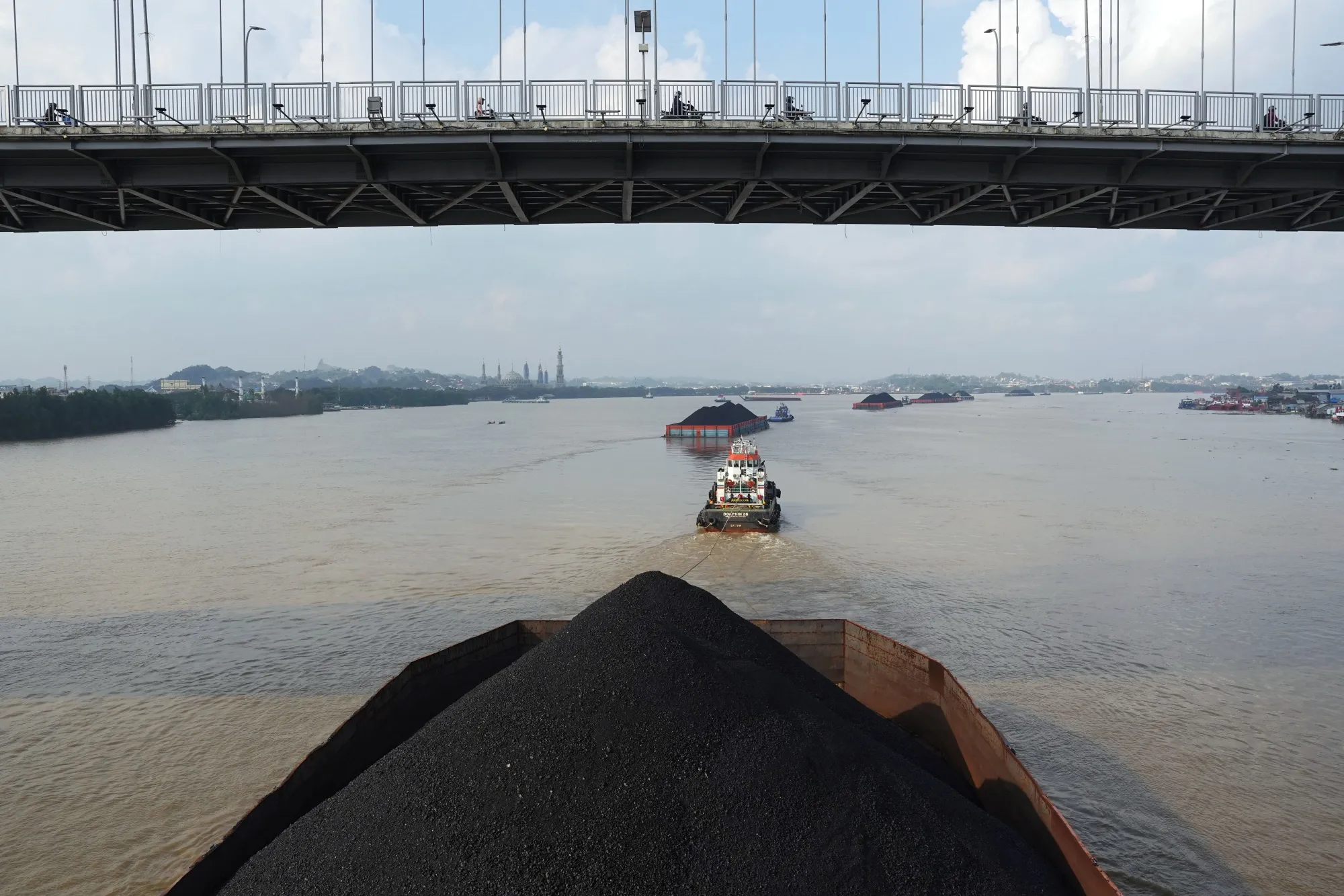 Barges transporting coal on the Mahakam River in Samarinda, East Kalimantan, Indonesia.