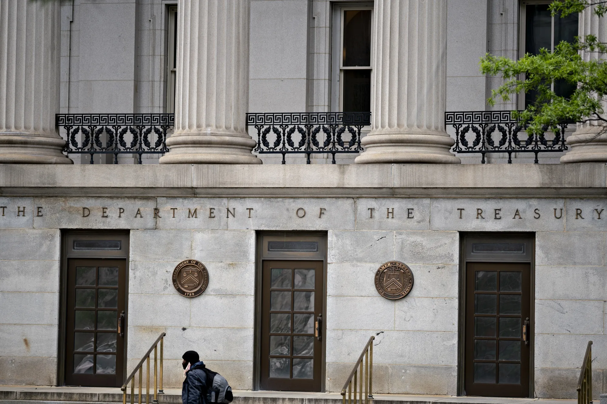 A pedestrian walks near the U.S. Treasury building in Washington.