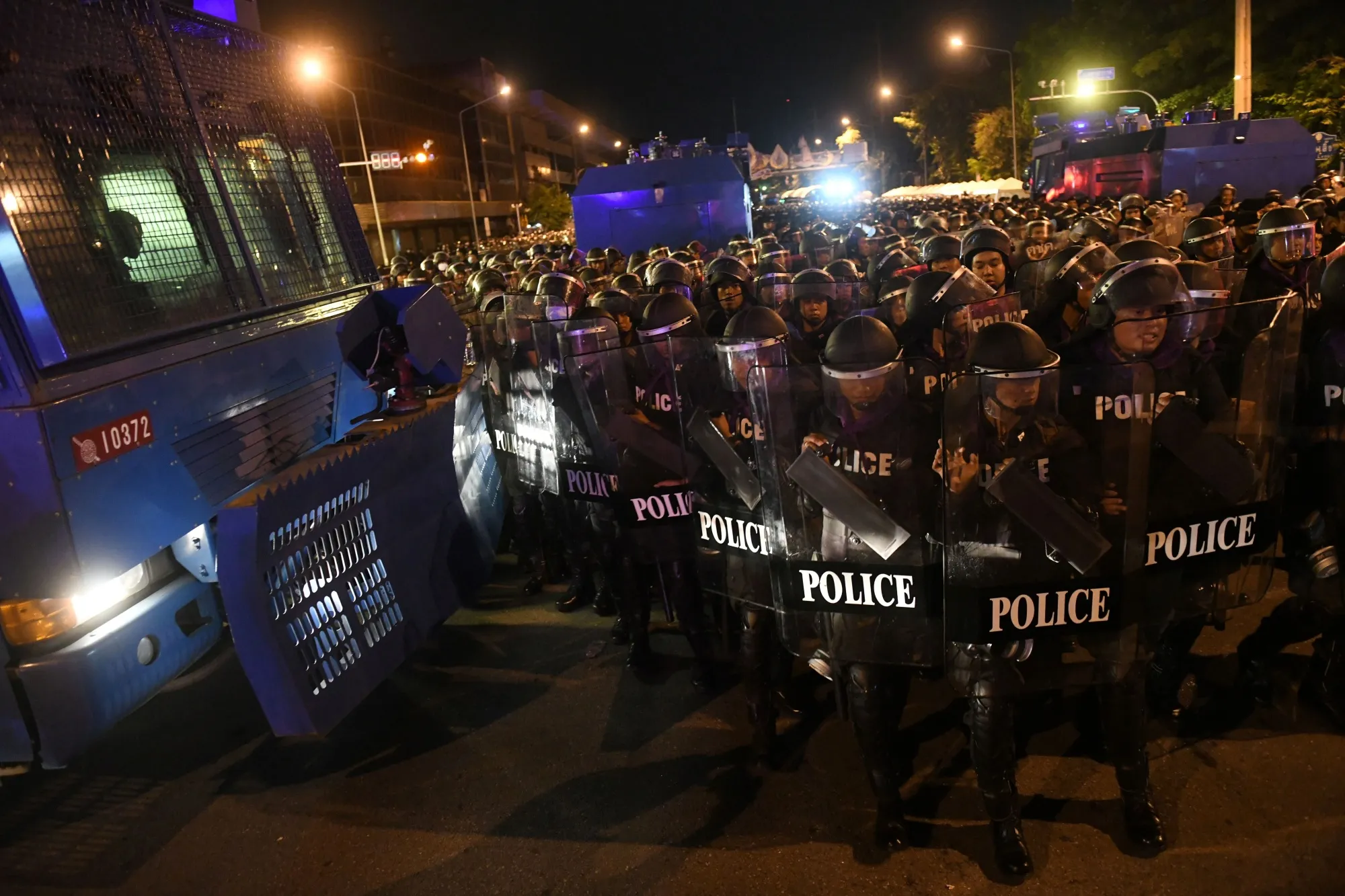 Riot police prepare to disperse protesters in Bangkok on Oct. 15.