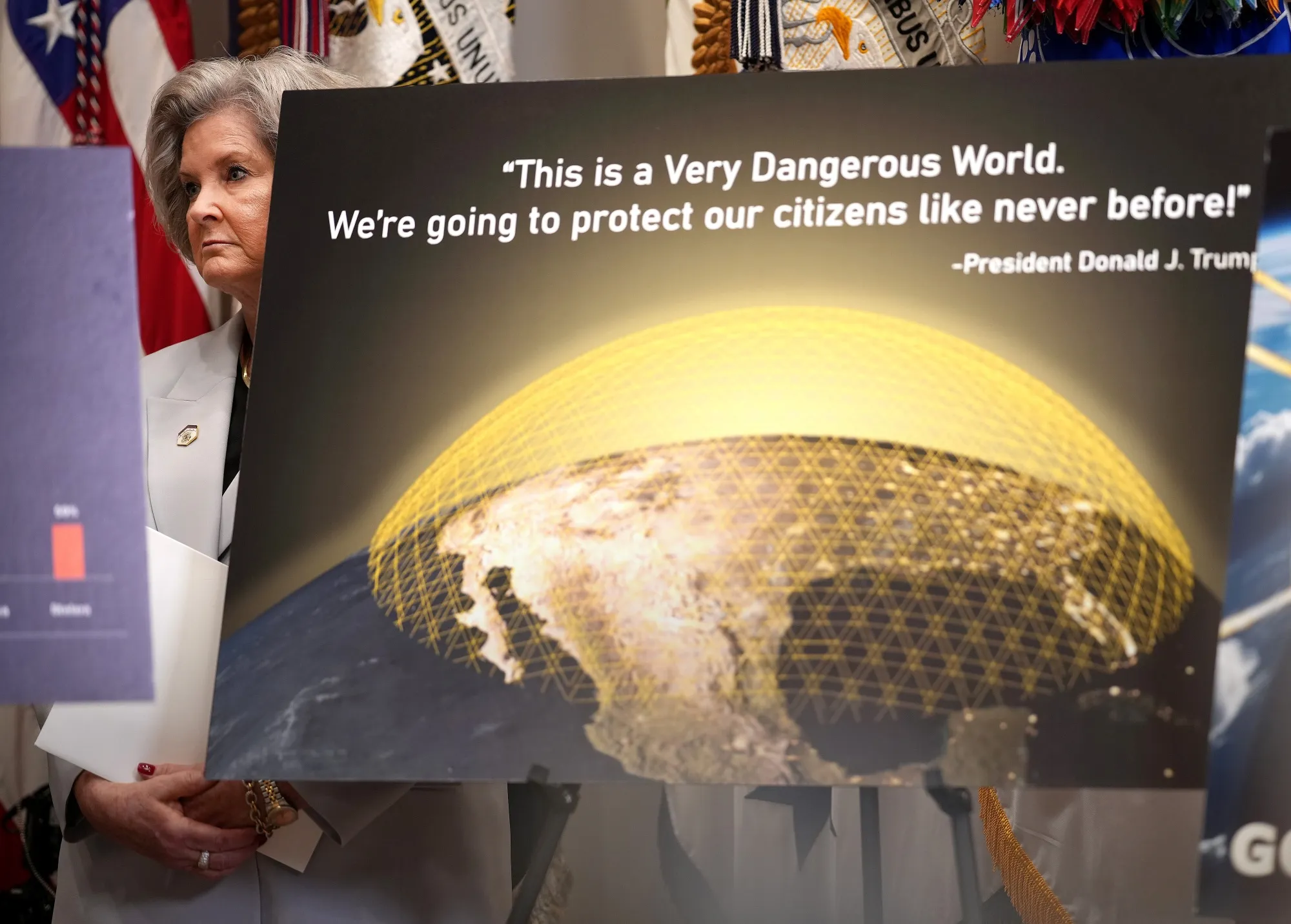 White House Chief of Staff Susie Wiles behind a chart on the Golden Dome missile defense system as&nbsp;President Donald Trump speaks during a press conference in the Roosevelt Room of the White House on May 12.