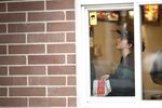A worker views a monitor at the drive-thru window of a McDonald's Corp. restaurant in Little Falls, NJ
