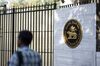 A pedestrian walks past the Reserve Bank of India (RBI) building in Mumbai.