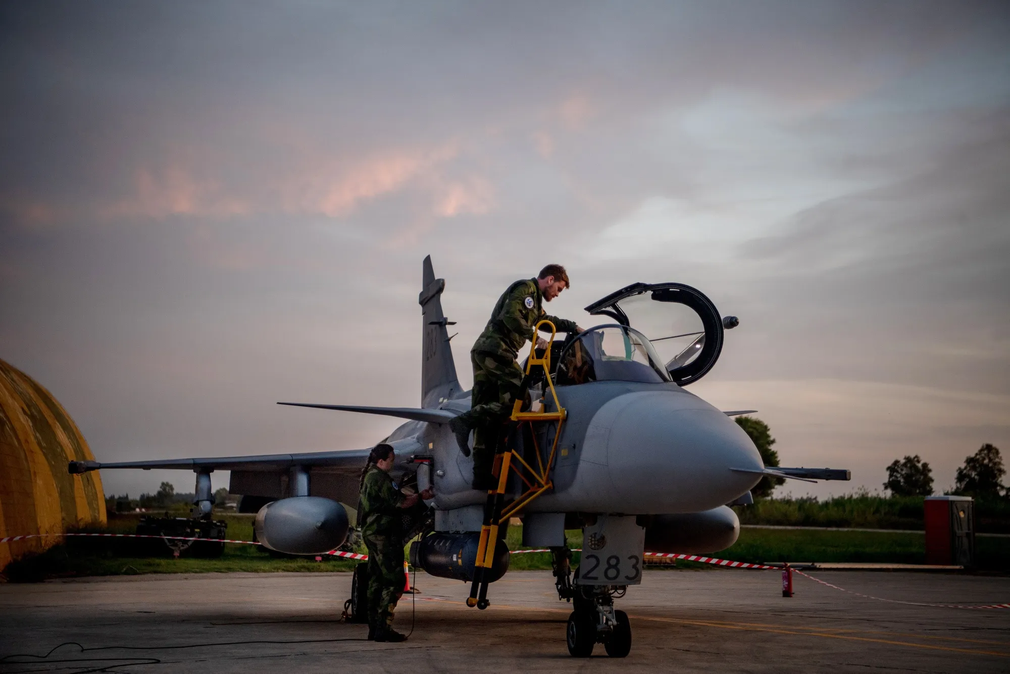 Ground crew prepare a Swedish Air Force Gripen fighter jet during a NATO training exercise.