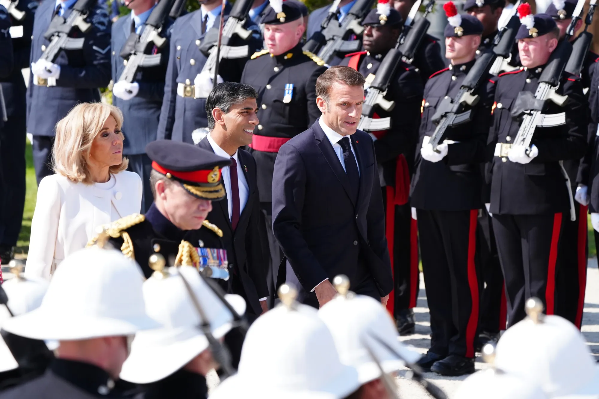 Emmanuel Macron with Rishi Sunak arrive for the UK national commemorative event.