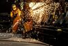 Workers use torches to smooth down the welded joints on railroad suspension parts at the Columbus Castings facility in Columbus, Ohio, U.S., on Wednesday, April 25, 2012. The U.S. Commerce Department\'s Bureau of Economic Analysis is scheduled to release gross domestic product (GDP) figures for the the first quarter of 2012 on April 27.