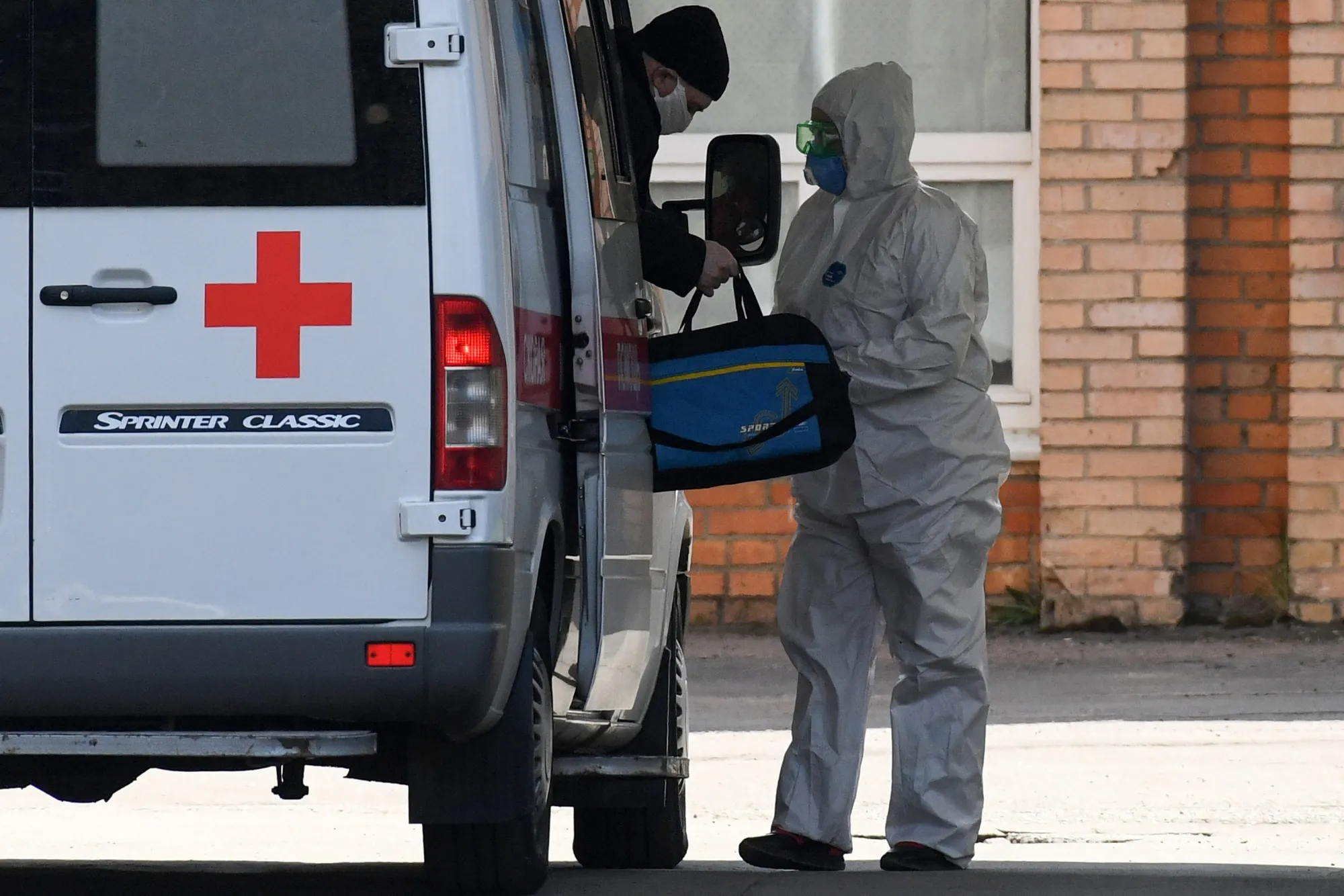 Health workers arrive at a hospital where patients infected with coronavirus are being treated in Khimki,