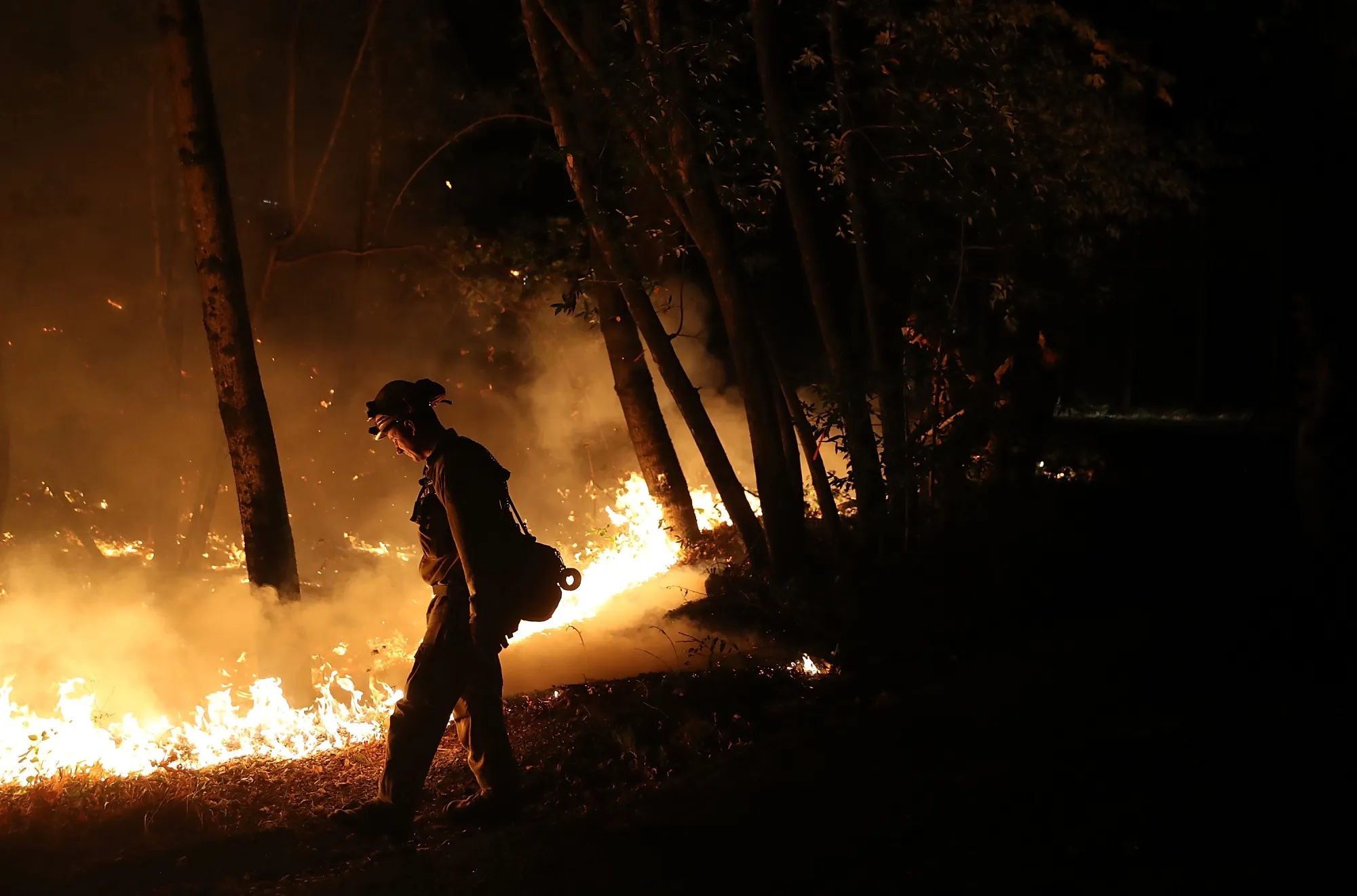 A California firefighter&nbsp;uses a drip torch during&nbsp;the Tubbs Fire near Calistoga, California in October 2017.&nbsp;