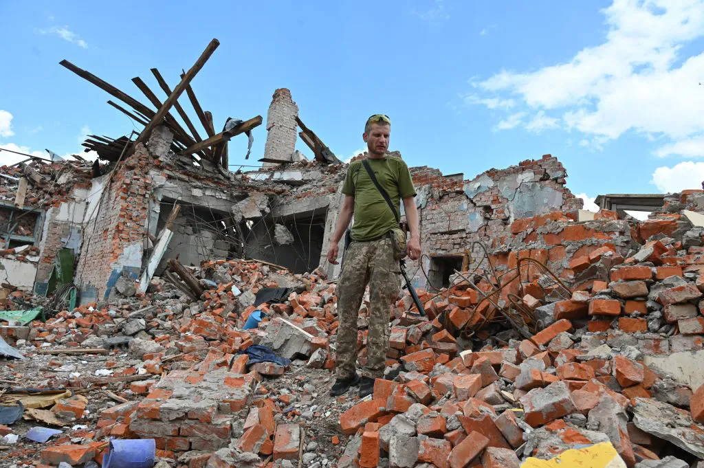 A Ukrainian serviceman inspects a destroyed building in Kharkiv, Ukraine,&nbsp;on July 5.