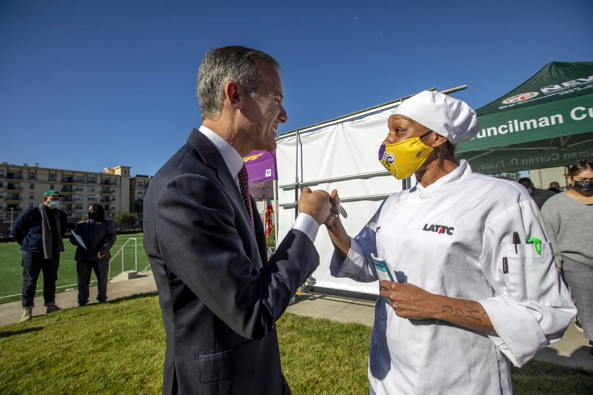 Los Angeles City Mayor Eric Garcetti, left, greets constituent Quiana Gomez after announcing&nbsp;the city's new guaranteed basic income pilot program. Such programs have grown in popularity during the pandemic.&nbsp;