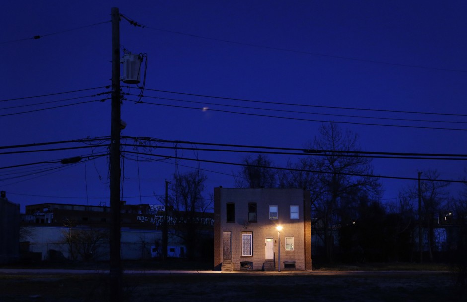 A pair of surviving rowhomes surrounded by vacant lots at dusk in Baltimore. The city has some 17,000 vacant buildings. 