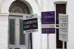 Estate agent &quot;To Let&quot; and &quot;Rent&quot; signs outside residential properties in the Queen's Park district of London.