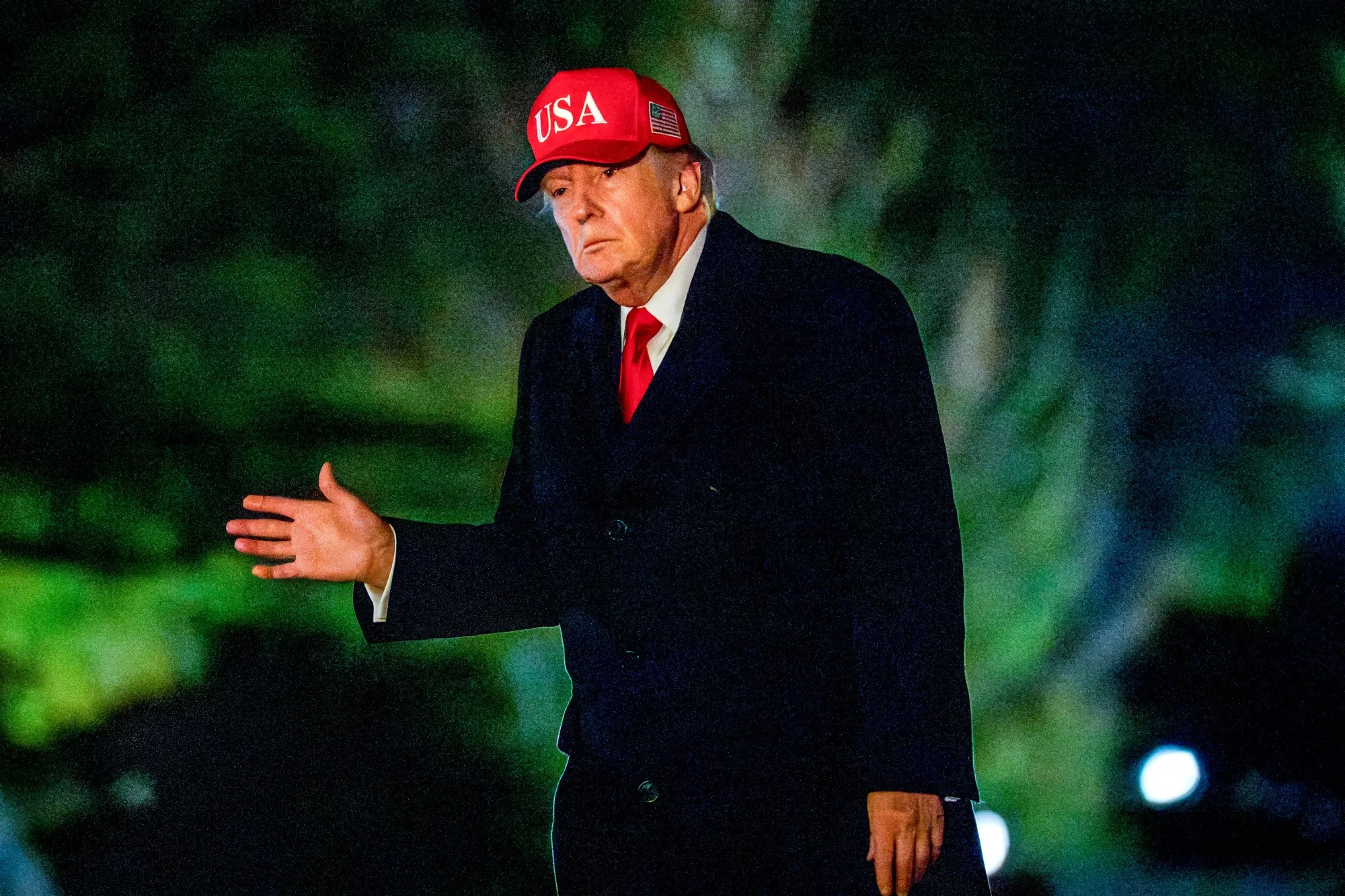 US President Donald Trump walks on the South Lawn of the White House after arriving on Sunday.