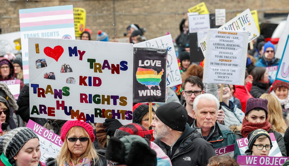 Demonstrators hold signs during &quot;Stand Up for Transgender Rights&quot; event to show their support for transgender equality, in Chicago, Illinois