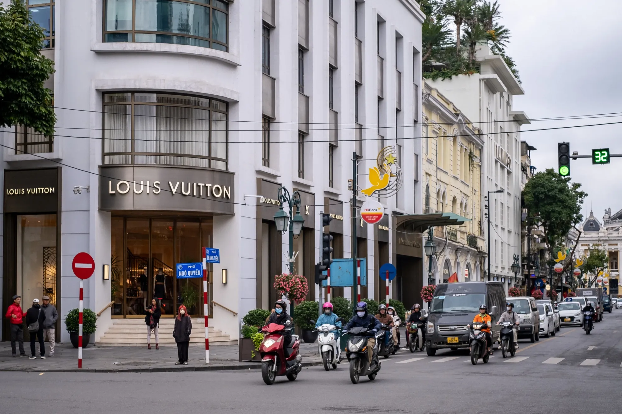Motorists pass by a Louis Vuitton store in downtown Hanoi earlier this year. Strict DUI legislation has shaken up Vietnam’s drinking culture.&nbsp;
