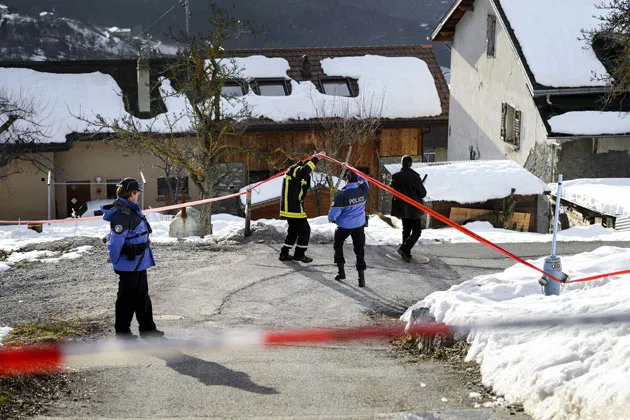 Police search for evidence on Jan. 3 in Daillon after a gunman opened fire in the village in southern Switzerland, killing three people and wounding two others