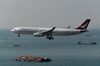 An Airbus SE A330-342 aircraft operated by Cathay Dragon, a unit of Cathay Pacific Airways Ltd., prepares to land at Hong Kong International Airport in Hong Kong, China, on Saturday, March 11, 2018. Cathay Pacific is expected to report a full-year net loss of HK$2.7 billion ($345 million) for 2017, after a first-half deficit of HK$2.05 billion, according to the median estimate in a Bloomberg News survey of five analysts.