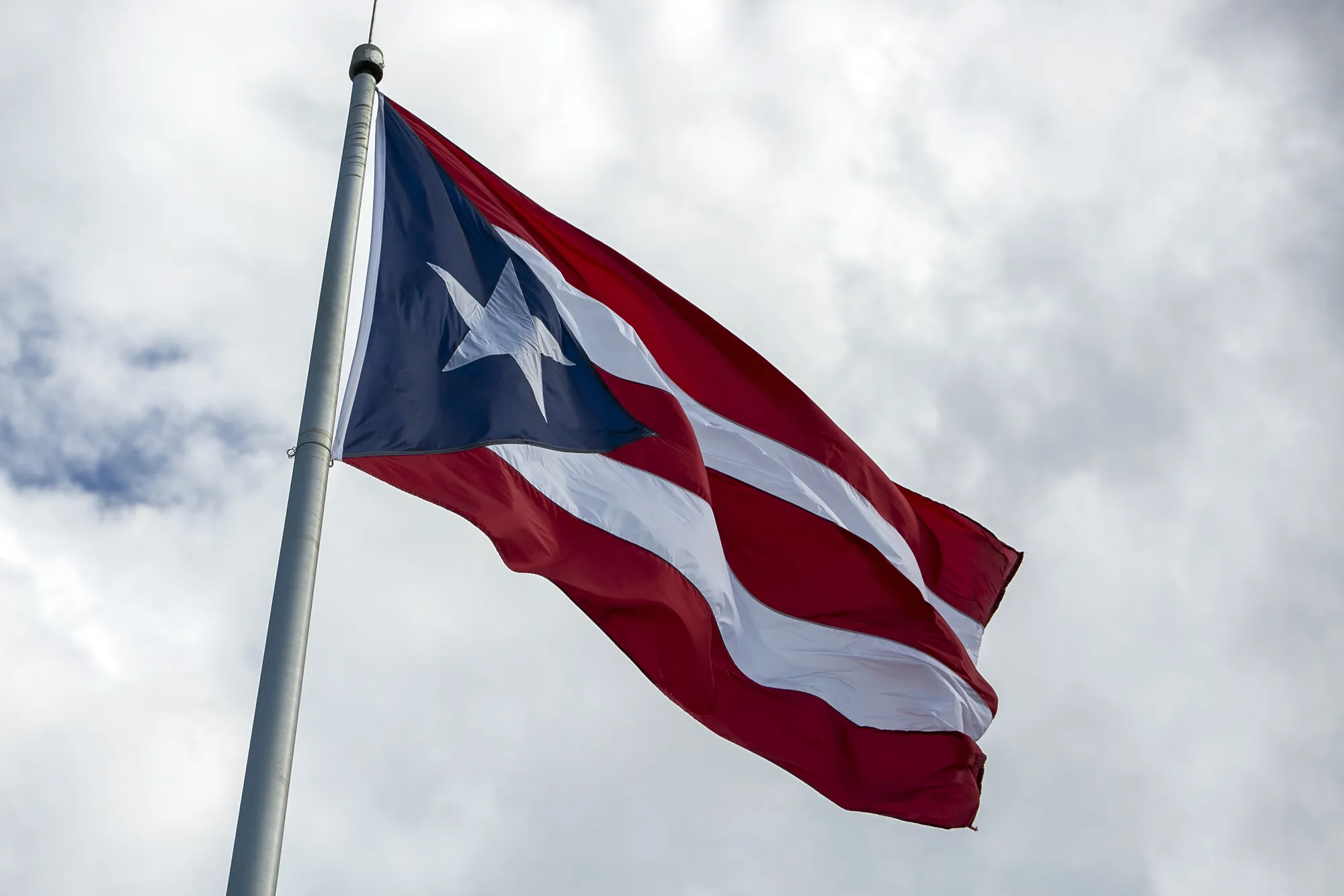 A Puerto Rican flag flies outside the Capitol of Puerto Rico building in San Juan, Puerto Rico.