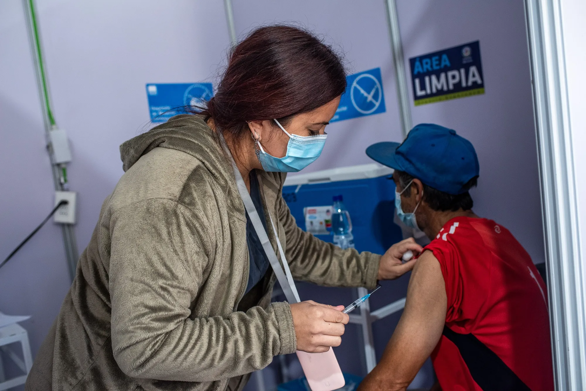 A health care worker administers a dose of the Sinovac Covid-19 vaccine in Santiago, on March 29.