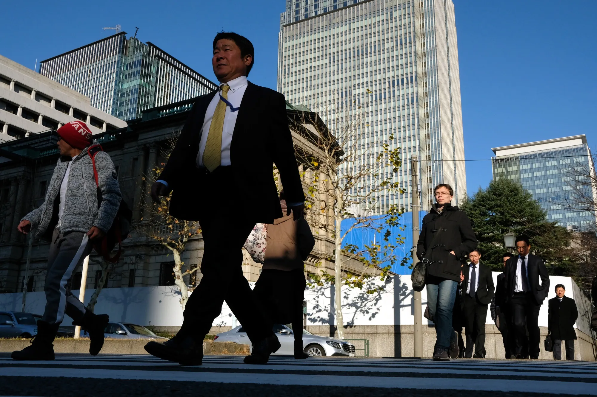 Pedestrians walk past the Bank of Japan (BOJ) headquarters in Tokyo, Japan on&nbsp;Jan. 4.