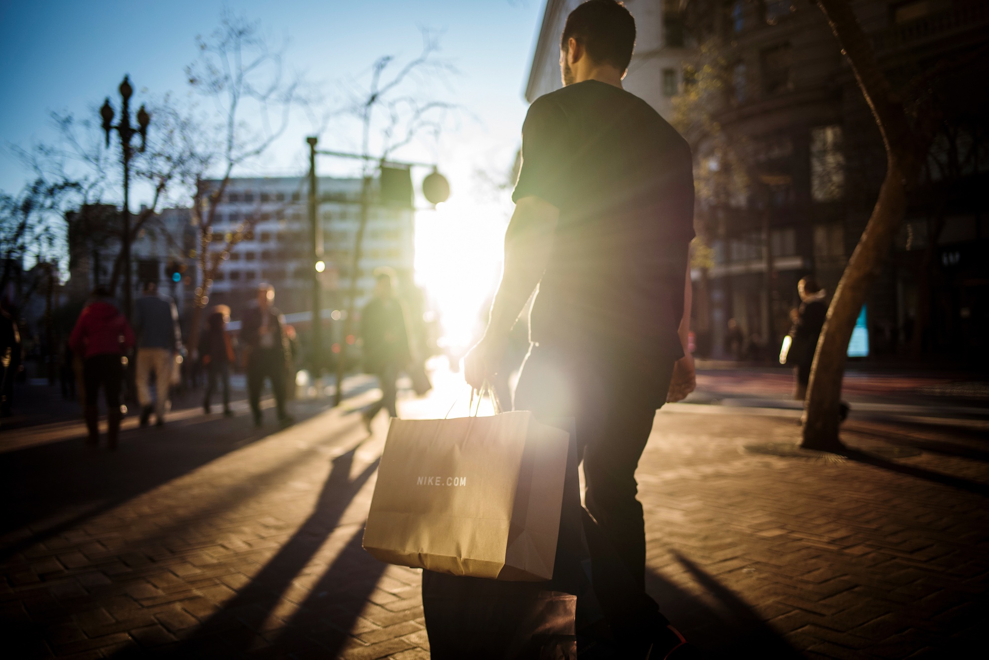 A pedestrian carries a shopping bag in San Francisco, California.
