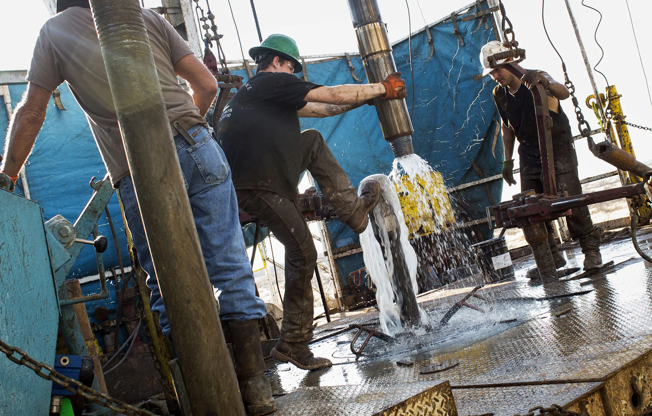 Workers connect drill bits and drill collars in Texas
