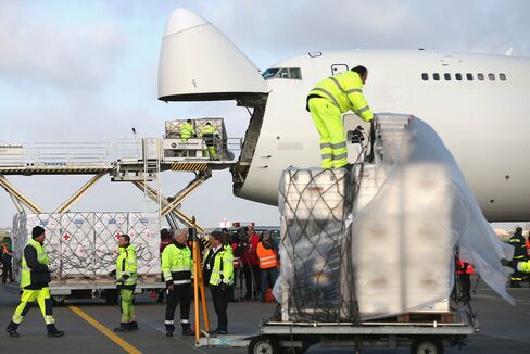 Workers load a shipment on to a Boeing 747 cargo plan.