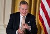 Former US President George H. W. Bush points to his wife Barbara Bush during an event in the East Room of the White House July 15, 2013 in Washington, DC.
