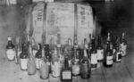 Bottles and barrel of confiscated whiskey (circa 1920-1932)
