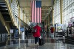 A traveler walks through Ronald Reagan National Airport (DCA) in Arlington, Virginia, U.S., on Monday, March 16, 2020.