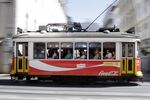 Visitors travel aboard a tram in Lisbon. Photographer: Pau Barrena/Bloomberg
