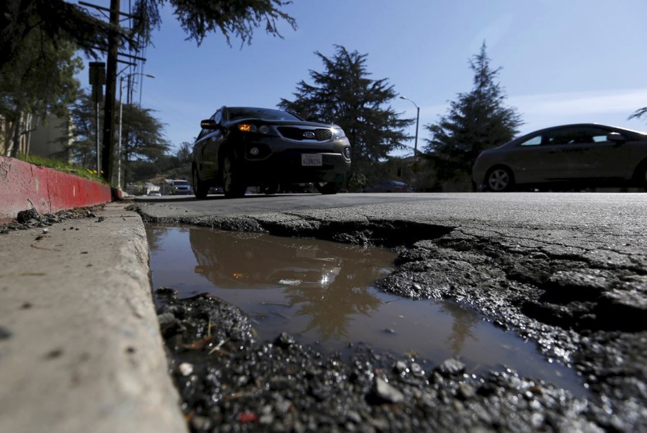 Road conditions such as this cratered asphalt in L.A. have pushed California cities to the top of the list of worst U.S. roads.