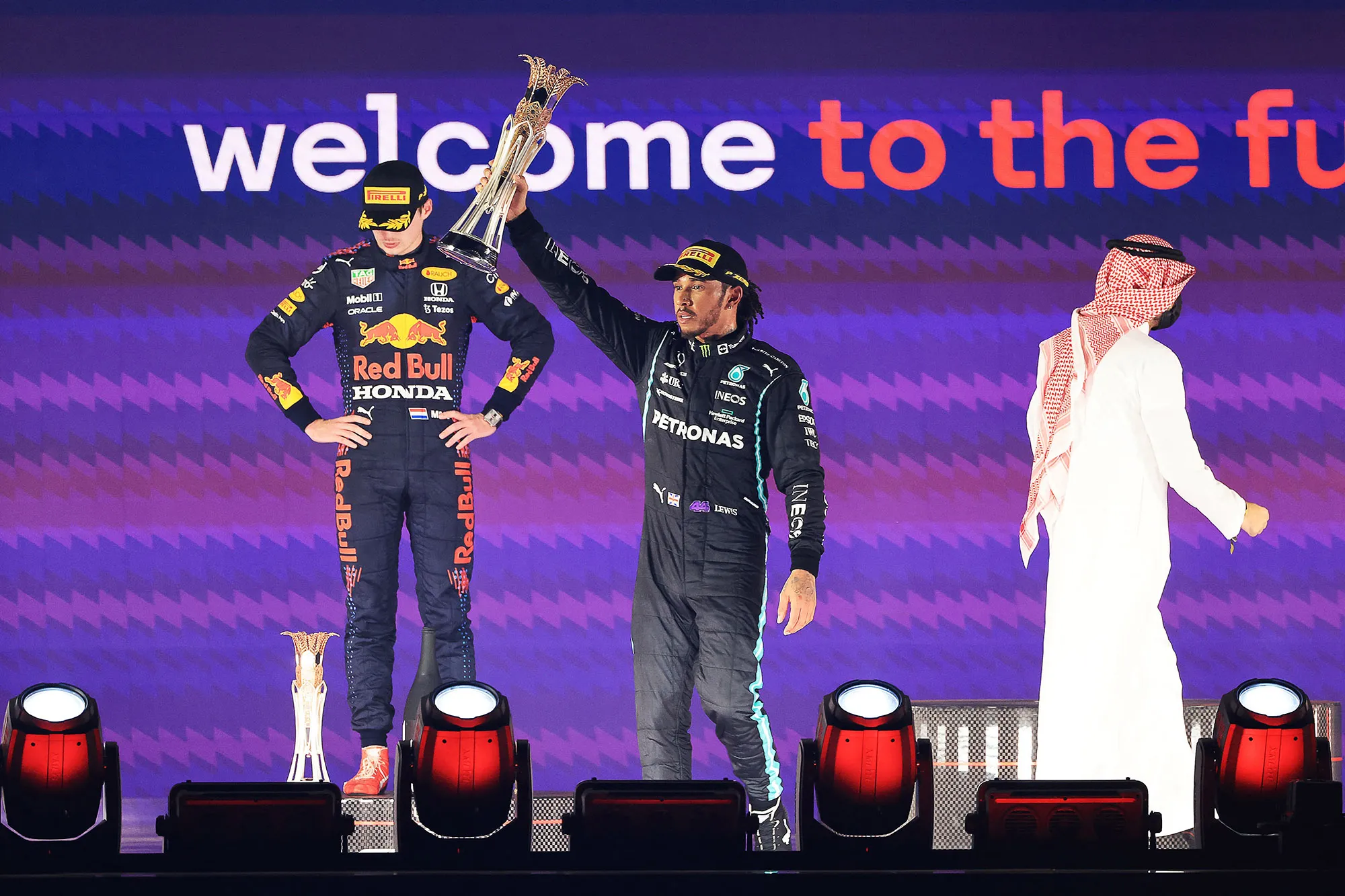 Lewis Hamilton with his trophy flanked by Max Verstappen&nbsp; in Jeddah on Dec.&nbsp;5.