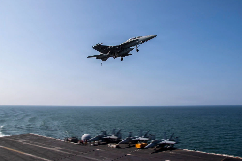 An F/A-18F Super Hornet flies over the USS Abraham Lincoln aircraft carrier on March 6.