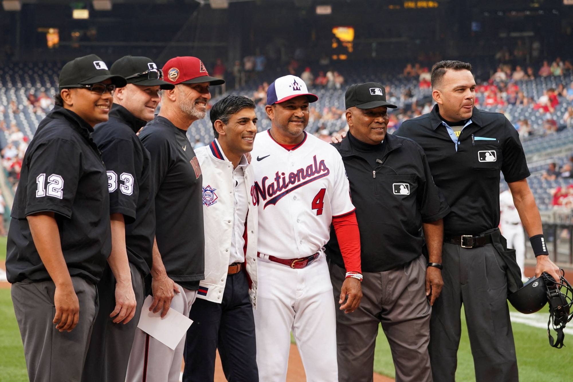 British Prime Minister Rishi Sunak poses with Washington Nationals mascot  Screech as he attends a Washington Nationals baseball game during his  visit to Washington, Wednesday, June 7, 2023. (Kevin Lamarque/Pool Photo via