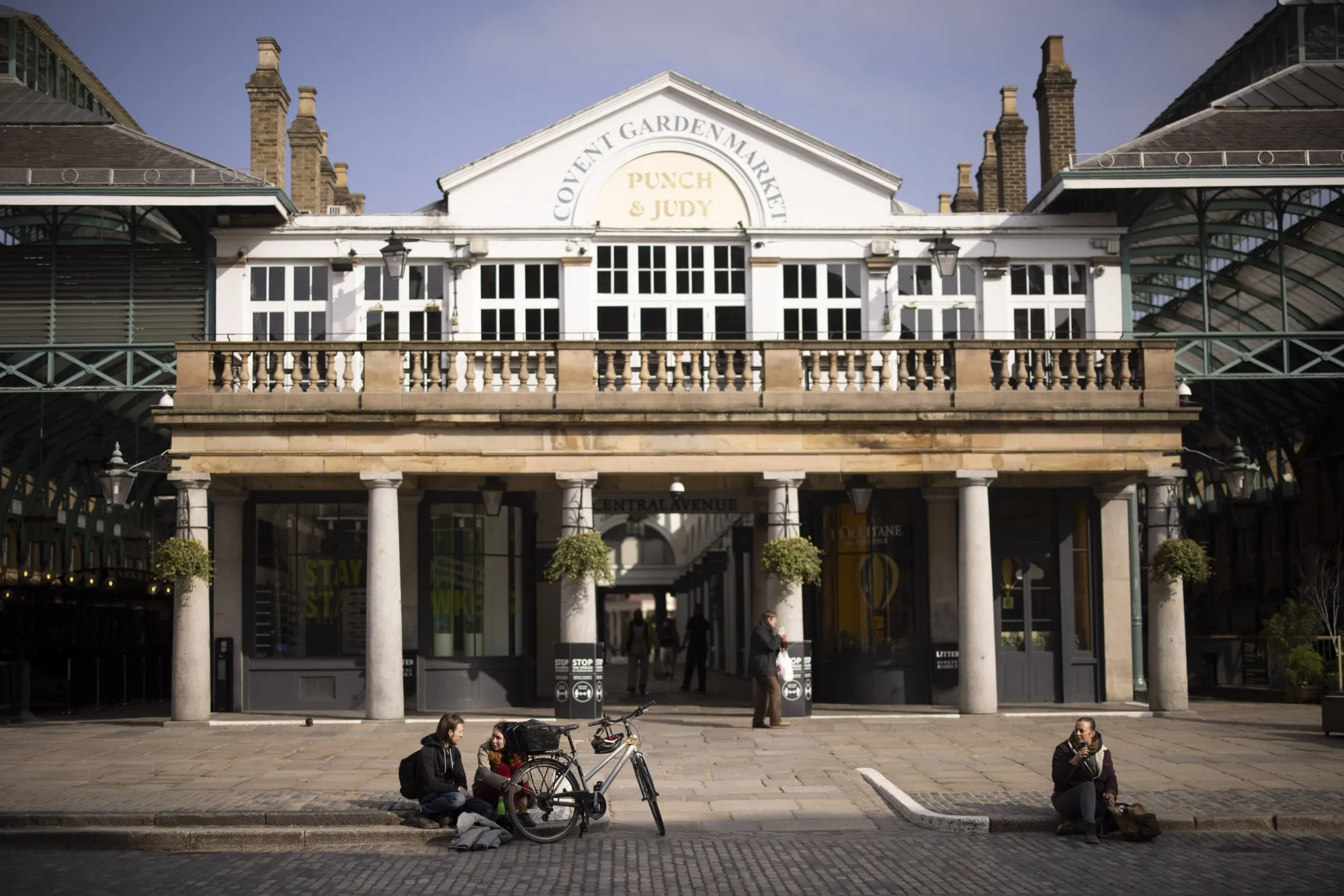 Pedestrians sit outside closed restaurants in Covent Garden in London&nbsp;on&nbsp;March 1.